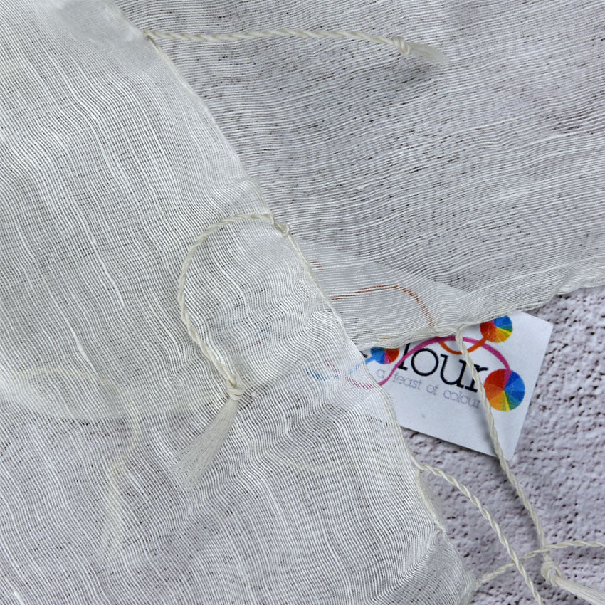 Close-up of silk linen scarf fabric with tassel edging and Kraft Kolour tag