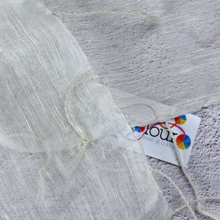 Close-up of silk linen scarf fabric with tassel edging and Kraft Kolour tag